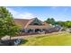 Upscale clubhouse with outdoor dining, brick patio, and manicured green space at 5113 Windance Pl, Holly Springs, NC 27540