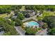 Aerial view of community pool, clubhouse, golf course, and neighborhood homes at 5113 Windance Pl, Holly Springs, NC 27540