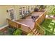 Spacious wooden deck featuring rocking chairs, a grill, and outdoor seating for entertaining at 5113 Windance Pl, Holly Springs, NC 27540