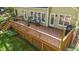 Elevated view of the wooden deck featuring an outdoor seating area, barbecue grill, and lush greenery at 5113 Windance Pl, Holly Springs, NC 27540