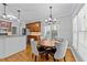 A view of the dining room with a chandelier and a table with chairs at 5113 Windance Pl, Holly Springs, NC 27540