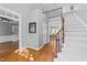 Spacious foyer with hardwood flooring, staircase, and views into other rooms at 5113 Windance Pl, Holly Springs, NC 27540