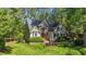 Attractive home with stone accents, arched window, tidy landscaping, and a lush green lawn at 5113 Windance Pl, Holly Springs, NC 27540
