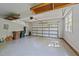 Spacious garage with clean epoxy floors, electric car charger, and natural light at 5113 Windance Pl, Holly Springs, NC 27540