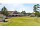 Golf course featuring a clubhouse with outdoor seating and putting green in a well-maintained setting at 5113 Windance Pl, Holly Springs, NC 27540