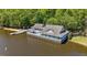 Beautiful lake house with deck and dock, offering waterfront living and scenic views at 5113 Windance Pl, Holly Springs, NC 27540