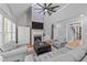 Spacious living room featuring a brick fireplace, vaulted ceiling, and comfortable seating at 5113 Windance Pl, Holly Springs, NC 27540