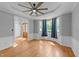 Living room boasts hardwood floors, white trim and large windows with blue curtains at 5113 Windance Pl, Holly Springs, NC 27540