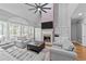 Cozy living room featuring a brick fireplace, vaulted ceiling, and comfortable seating at 5113 Windance Pl, Holly Springs, NC 27540