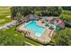 Aerial view of community pool with clean blue water, sun umbrellas, and surrounding trees at 5113 Windance Pl, Holly Springs, NC 27540