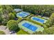 Overhead view of community tennis courts with professional nets and manicured landscaping at 5113 Windance Pl, Holly Springs, NC 27540