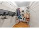 Organized walk-in closet with metal shelving and wooden floors at 5113 Windance Pl, Holly Springs, NC 27540
