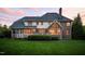 Expansive backyard featuring a well-manicured lawn and a charming brick home with large windows at 10 Twinleaf Pl, Durham, NC 27705