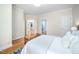 Bedroom featuring light walls, hardwood floors, and doorways leading to other rooms at 10 Twinleaf Pl, Durham, NC 27705