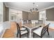 Dining room with a view of the entry way, modern chandelier, wainscoting and stylish decor at 10 Twinleaf Pl, Durham, NC 27705