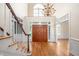 Grand foyer features hardwood floors, double doors, staircase, chandelier, and an abundance of natural light at 10 Twinleaf Pl, Durham, NC 27705