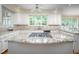Kitchen island featuring a granite countertop, gas stove, and stainless steel appliances at 10 Twinleaf Pl, Durham, NC 27705
