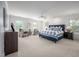 Spacious main bedroom featuring many windows for natural light and a sitting area with comfortable chairs at 10 Twinleaf Pl, Durham, NC 27705