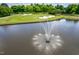 Picturesque golf course with a pond featuring a water fountain, surrounded by lush green fairways and manicured lawns at 10 Twinleaf Pl, Durham, NC 27705