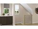 Hallway with built-in cabinets, a window with natural light, and a baby gate at 1037 Zelkova Ln, Chapel Hill, NC 27517