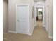 Hallway with carpet, white doors, and framed art on the walls at 1037 Zelkova Ln, Chapel Hill, NC 27517