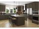 Modern kitchen features stainless steel appliances, a large island with seating and beautiful wooden cabinets at 1037 Zelkova Ln, Chapel Hill, NC 27517