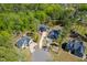 Overhead view of the property and neighboring homes with well-manicured lawns and circular driveways at 104 Blue Finch Ct, Youngsville, NC 27596