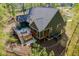 Aerial view of a home, including a deck, patio, fenced in backyard, and garden area at 104 Blue Finch Ct, Youngsville, NC 27596