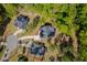 An aerial view of the house nestled among mature trees, showcasing its landscaping and the surrounding neighborhood at 104 Blue Finch Ct, Youngsville, NC 27596