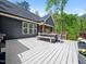 View of the back of the house featuring a white deck with a wooden table and chairs at 104 Blue Finch Ct, Youngsville, NC 27596