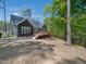 Back exterior of a home featuring a deck and well-manicured backyard with a black metal fence at 104 Blue Finch Ct, Youngsville, NC 27596