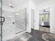 Bathroom showcasing large glass walk-in shower with a view to the bedroom at 104 Blue Finch Ct, Youngsville, NC 27596