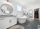 Bright bathroom featuring a soaking tub, granite counters, and a view to the walk-in closet at 104 Blue Finch Ct, Youngsville, NC 27596