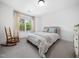 Comfortable bedroom with a cozy rocking chair and bright window at 104 Blue Finch Ct, Youngsville, NC 27596