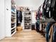 Spacious walk-in closet with custom shelving for shoes, clothing, and accessories at 104 Blue Finch Ct, Youngsville, NC 27596
