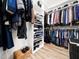 Custom walk-in closet with multiple shelves and hanging storage for clothes and shoes at 104 Blue Finch Ct, Youngsville, NC 27596