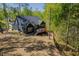 View of modern home featuring a deck, fenced yard, and meticulous landscaping surrounded by lush greenery at 104 Blue Finch Ct, Youngsville, NC 27596