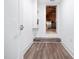 Hallway with wooden floors leading to a doorway at 104 Blue Finch Ct, Youngsville, NC 27596