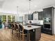 Open kitchen boasts a large island with seating, pendant lights, and stainless steel appliances at 104 Blue Finch Ct, Youngsville, NC 27596