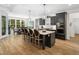 Open-concept eat-in kitchen features a center island with seating, black cabinets, and pendant lighting at 104 Blue Finch Ct, Youngsville, NC 27596