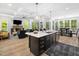 Open floor plan featuring a kitchen with a center island, and a view of the living room with fireplace at 104 Blue Finch Ct, Youngsville, NC 27596