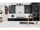 Close-up view of kitchen island with sink and stainless steel appliances at 104 Blue Finch Ct, Youngsville, NC 27596