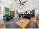 Open-concept living room with coffered ceiling, fireplace, and views of the kitchen and screened-in porch at 104 Blue Finch Ct, Youngsville, NC 27596