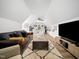 Bright living room featuring vaulted ceilings and a comfortable seating area at 104 Blue Finch Ct, Youngsville, NC 27596
