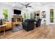 Spacious living room with coffered ceilings, fireplace, modern furniture, and seamless outdoor access at 104 Blue Finch Ct, Youngsville, NC 27596