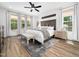 Serene main bedroom boasts natural light, wood floors, a ceiling fan, and refined decor at 104 Blue Finch Ct, Youngsville, NC 27596