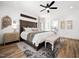 Inviting main bedroom with wood floors, a ceiling fan, refined decor, and neutral color palette at 104 Blue Finch Ct, Youngsville, NC 27596