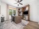 Bright home office with wood floors, modern desk, built-in shelves, and neutral decor at 104 Blue Finch Ct, Youngsville, NC 27596