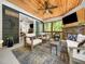 Inviting outdoor porch with comfortable seating and a stone fireplace at 104 Blue Finch Ct, Youngsville, NC 27596