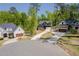Neighborhood street featuring a home with a long driveway, 2 car garage, and manicured lawn at 104 Blue Finch Ct, Youngsville, NC 27596